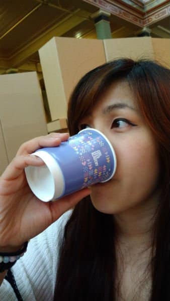 Stephanie from girl geek academy drinking from a branded coffee cup