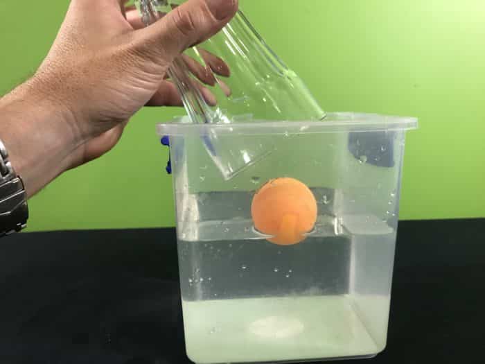 Air takes up space science experiment - covering the floating ping pong ball with a glass