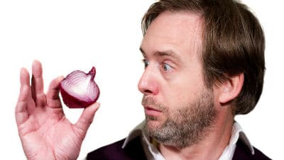 Sean Elliot holding half a red onion