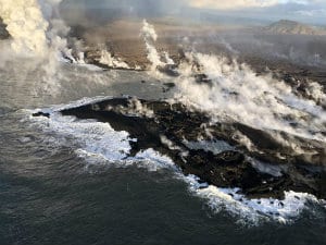 Volcano peninsula kilauea white steam ocean black rock