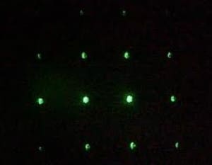 laser diffraction pattern black background green laser spots arranged in a grid