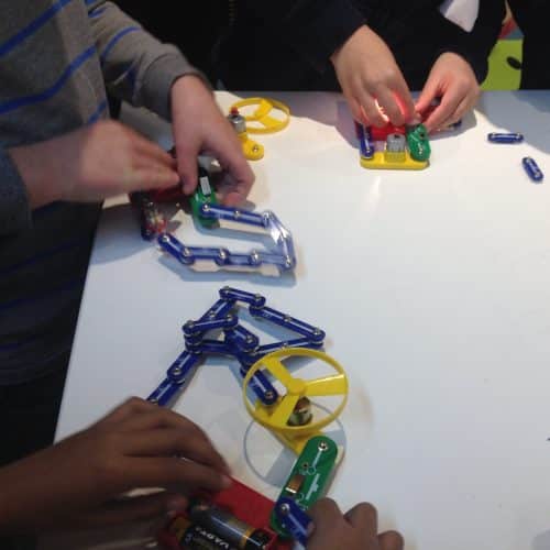 Students creating circuits using the clip circuit resources on a table