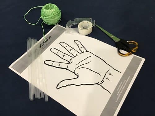 The materials seen in the picture are straw, paper,scissors, string and tape.